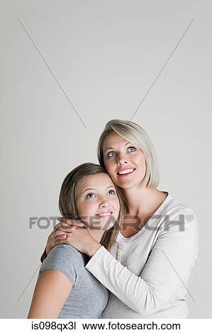 Stock Image - Mother and daughter looking up. Fotosearch