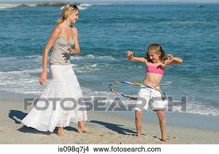 Mother and daughter with plastic hoop View Large Photo Image Picture - Mother and daughter with plastic hoop. Fotosearch