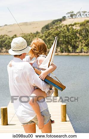 Stock Image - Mother and daughter with toy boat. Fotosearch