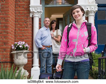 Picture - Mother and father watching daughter leave. Fotosearch