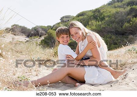 Stock Image - Mother and son on beach. Fotosearch