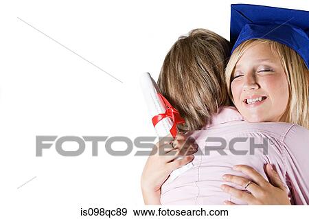 Stock Photo - Mother hugging graduating daughter. Fotosearch