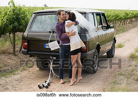 Newlywed couple by vehicle View Large Photo Image Stock Image - Newlywed couple by vehicle. Fotosearch