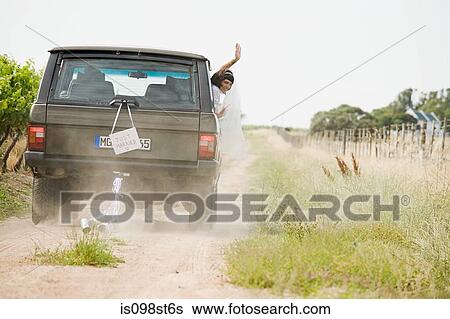 Newlywed woman waving from vehicle View Large Photo Image Stock Photograph - Newlywed woman waving from vehicle. Fotosearch