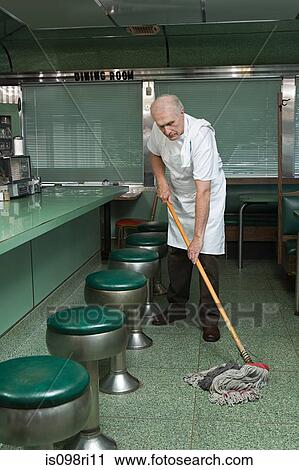 Stock Image - Old cleaner mopping a diner floor. Fotosearch