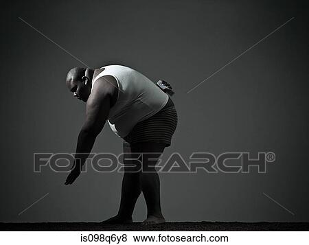 Stock Photo - Overweight man bending over. Fotosearch