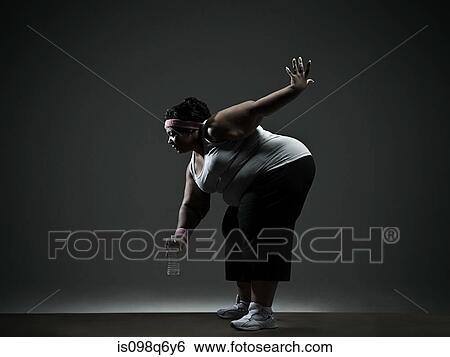 Stock Photograph - Overweight woman exercising. Fotosearch