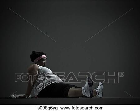 Stock Image - Overweight woman in sports clothing. Fotosearch
