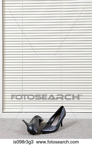 Pair of high heeled shoes in front of venetian blinds View Large Photo Image Stock Image - Pair of high heeled shoes in front of venetian blinds. Fotosearch