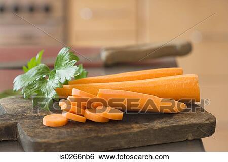 Peeled carrots on a cutting board View Large Photo Image Stock Photograph - Peeled carrots on a cutting board. Fotosearch