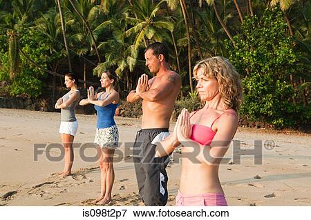 People practicing yoga on a beach View Large Photo Image Stock Photo - People practicing yoga on a beach. Fotosearch