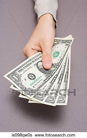 Person holding dollar bills View Large Photo Image Stock Photograph - Person holding dollar bills. Fotosearch