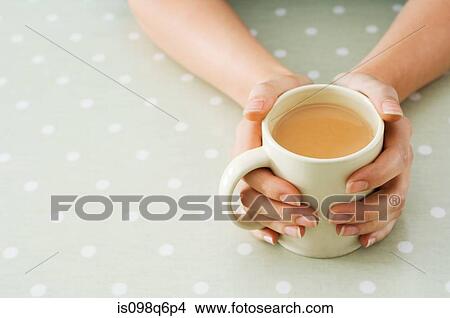 Person holding tea View Large Photo Image Picture - Person holding tea. Fotosearch