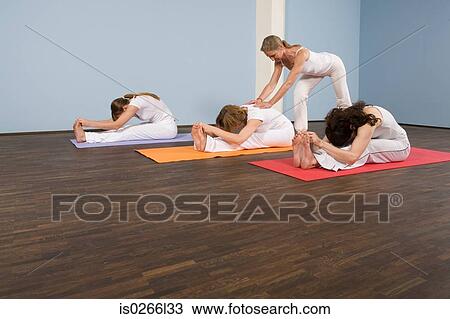 Personal trainer teaching yoga View Large Photo Image Stock Image - Personal trainer teaching yoga. Fotosearch