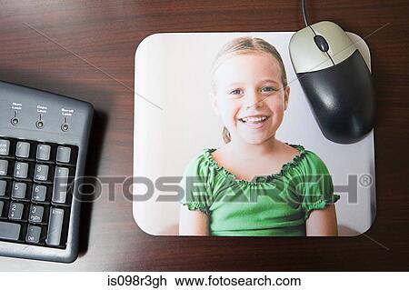 Stock Image - Personalised mousepad with photo of little girl on it. Fotosearch