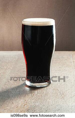 Pint of beer on table View Large Photo Image Stock Image - Pint of beer on table. Fotosearch