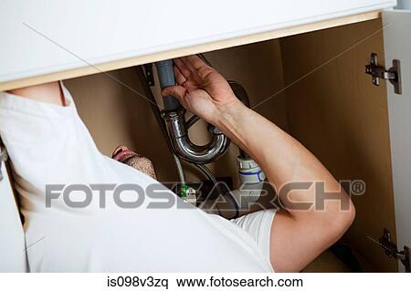Plumber fixing sink View Large Photo Image Stock Photography - Plumber fixing sink. Fotosearch