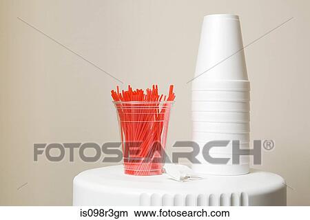 Picture - Polystyrene cups and plastic stirrers on top of coffee machine. Fotosearch