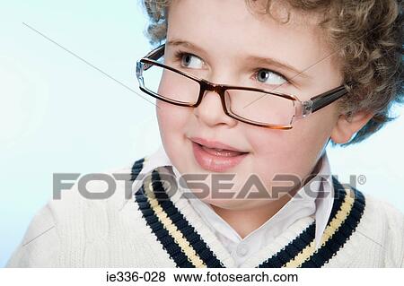 Portrait of a boy wearing eyeglasses View Large Photo Image Stock Photo - Portrait of a boy wearing eyeglasses. Fotosearch