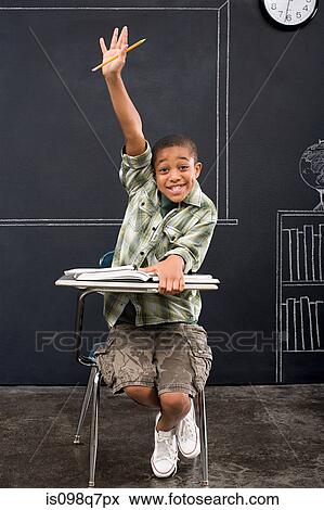 Stock Photo - Portrait of a boy with his arm raised. Fotosearch