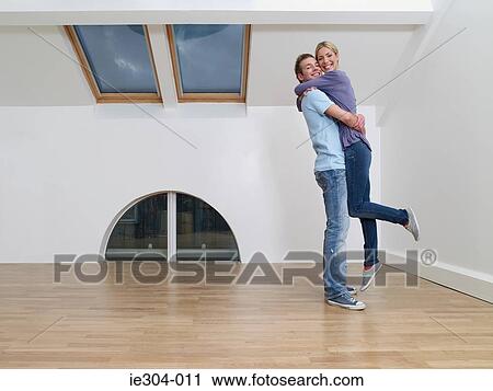 Stock Image - Portrait of a couple in their new home. Fotosearch