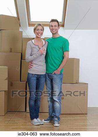 Stock Image - Portrait of a couple in their new home. Fotosearch