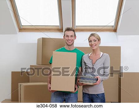 Portrait of a couple in their new home View Large Photo Image Stock Photo - Portrait of a couple in their new home. Fotosearch