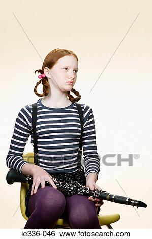 Portrait of a girl holding a clarinet View Large Photo Image Stock Photograph - Portrait of a girl holding a clarinet. Fotosearch