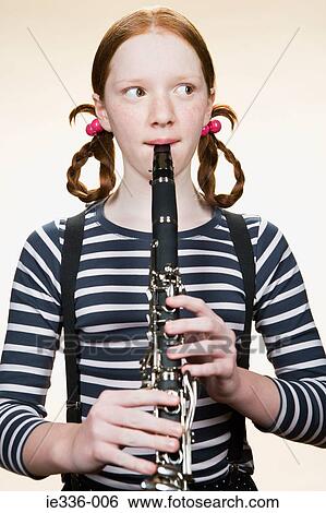 Portrait of a girl playing a clarinet View Large Photo Image Stock Photograph - Portrait of a girl playing a clarinet. Fotosearch