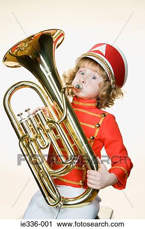 Stock Image - Portrait of a girl playing the tuba. Fotosearch