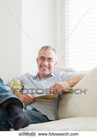 Portrait of a man holding a book View Large Photo Image Stock Image - Portrait of a man holding a book. Fotosearch