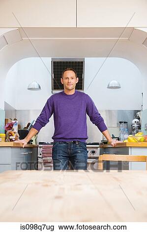 Stock Image - Portrait of a man in a kitchen. Fotosearch