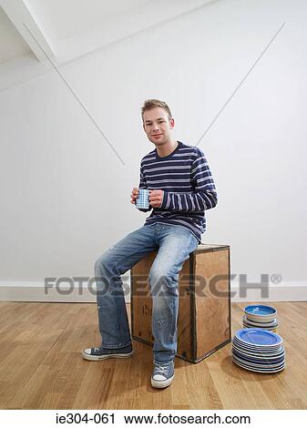 Portrait of a man taking a break in his new home View Large Photo Image Stock Image - Portrait of a man taking a break in his new home. Fotosearch