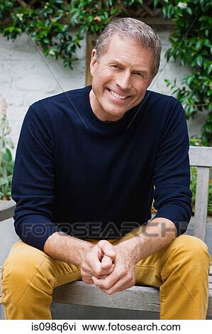 Portrait of a senior man sat on a bench View Large Photo Image Stock Image - Portrait of a senior man sat on a bench. Fotosearch