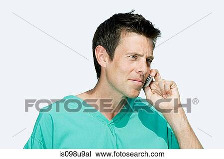 Portrait of a surgeon on cellphone View Large Photo Image Stock Image - Portrait of a surgeon on cellphone. Fotosearch