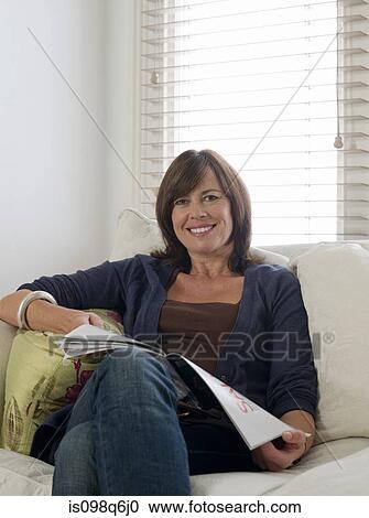 Portrait of a woman holding a magazine View Large Photo Image Stock Image - Portrait of a woman holding a magazine. Fotosearch