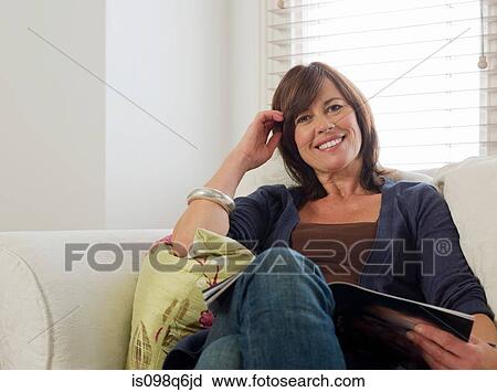 Portrait of a woman holding a magazine View Large Photo Image Stock Image - Portrait of a woman holding a magazine. Fotosearch