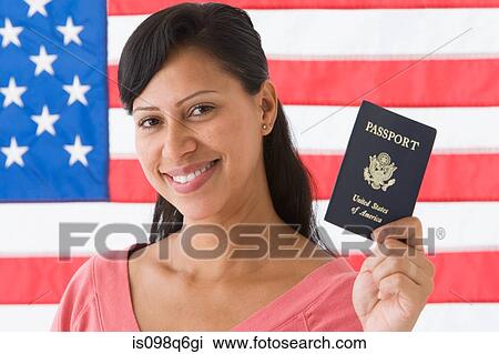 Stock Image - Portrait of a woman holding a passport. Fotosearch