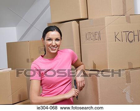 Stock Photo - Portrait of a woman moving house. Fotosearch