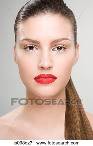 Stock Image - Portrait of a woman wearing red lipstick. Fotosearch