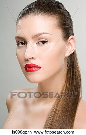 Stock Image - Portrait of a woman wearing red lipstick. Fotosearch