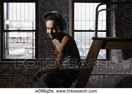 Stock Photograph - Portrait of a young man wearing a hat. Fotosearch