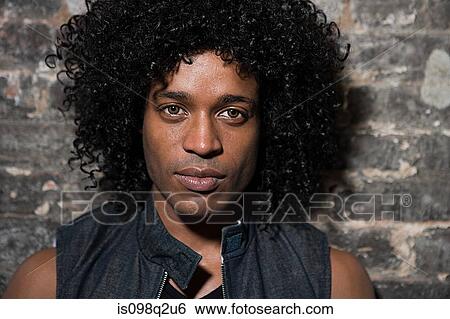 Portrait of a young man with curly hair View Large Photo Image Stock Photograph - Portrait of a young man with curly hair. Fotosearch