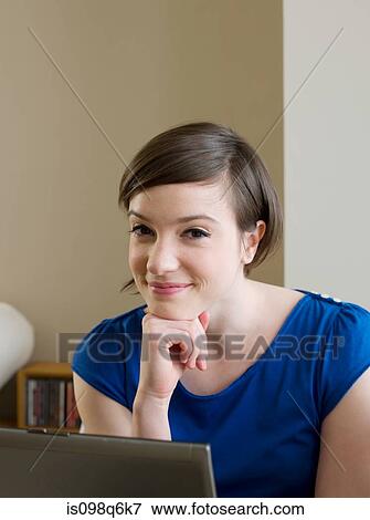 Stock Photo - Portrait of a young woman and a laptop. Fotosearch
