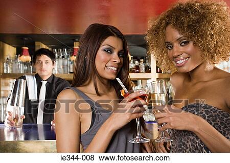 Portrait of friends at a bar in a club View Large Photo Image Stock Photo - Portrait of friends at a bar in a club. Fotosearch