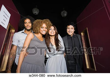 Stock Image - Portrait of friends in a nightclub. Fotosearch