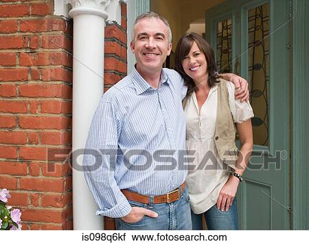 Portrait of man and woman at their front door View Large Photo Image Stock Image - Portrait of man and woman at their front door. Fotosearch