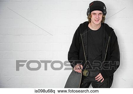 Portrait of teenage boy with skateboard View Large Photo Image Stock Photography - Portrait of teenage boy with skateboard. Fotosearch