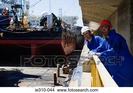 Picture - Portrait of two harbour workers. Fotosearch