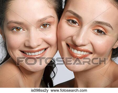 Stock Photo - Portrait of two young women side by side. Fotosearch